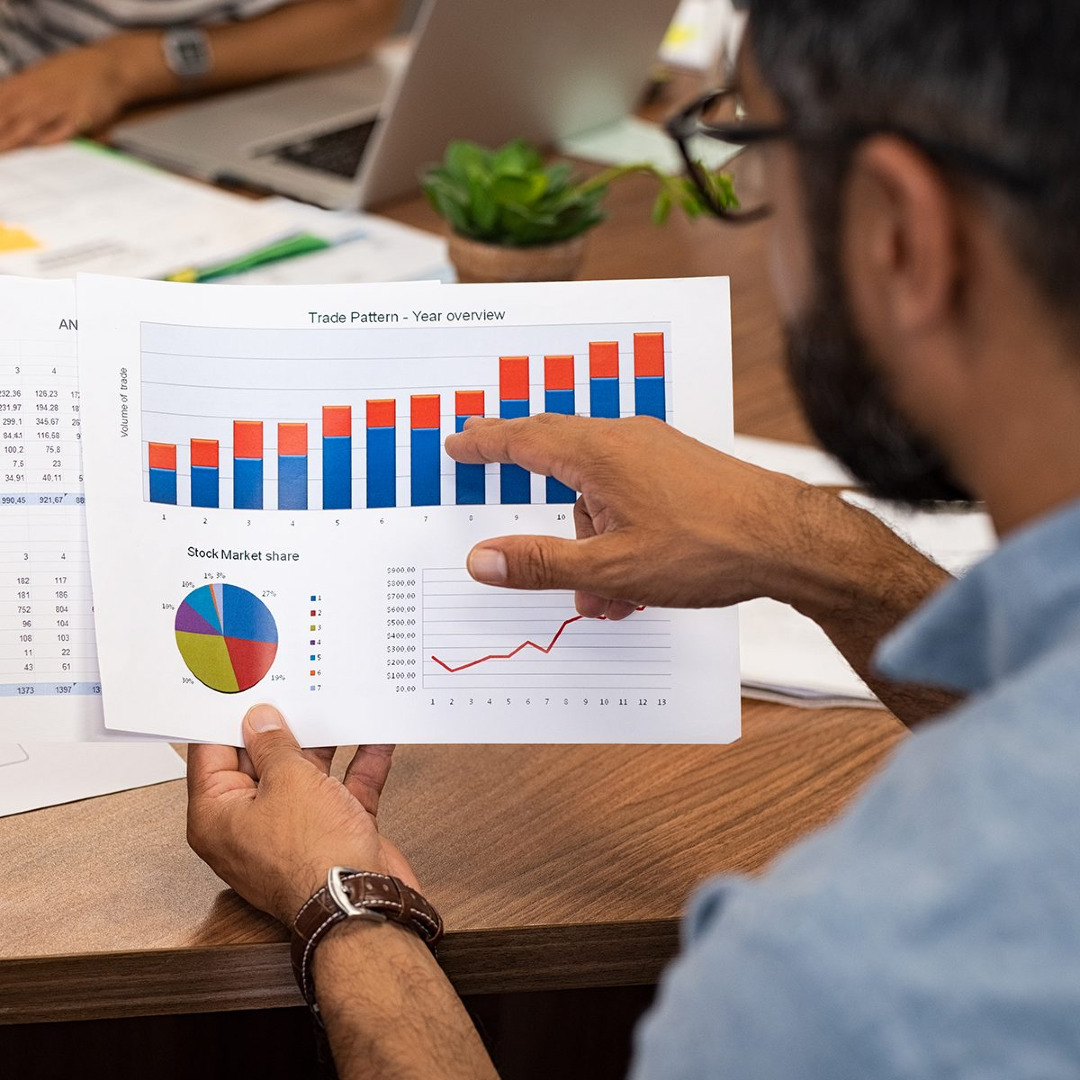 Picture of man holding accounting chart