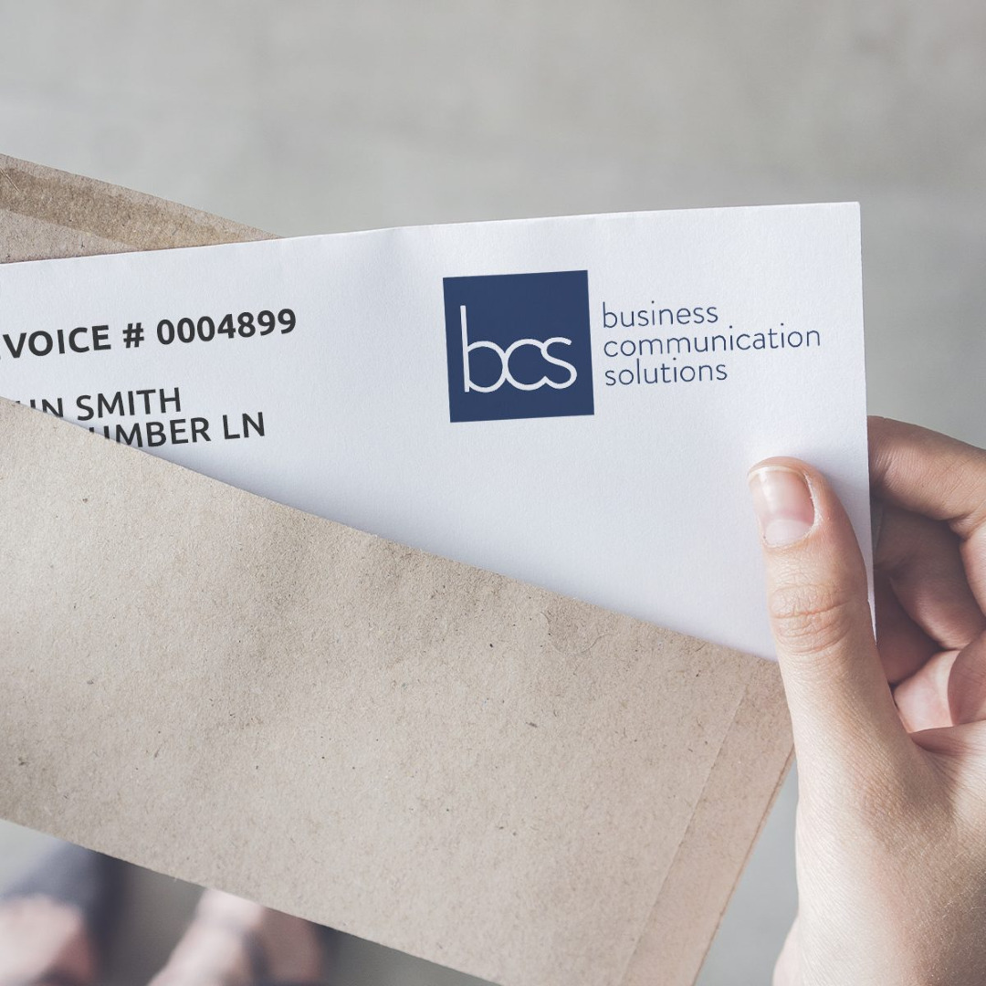 Picture of a person removing an envelope with an invoice letter