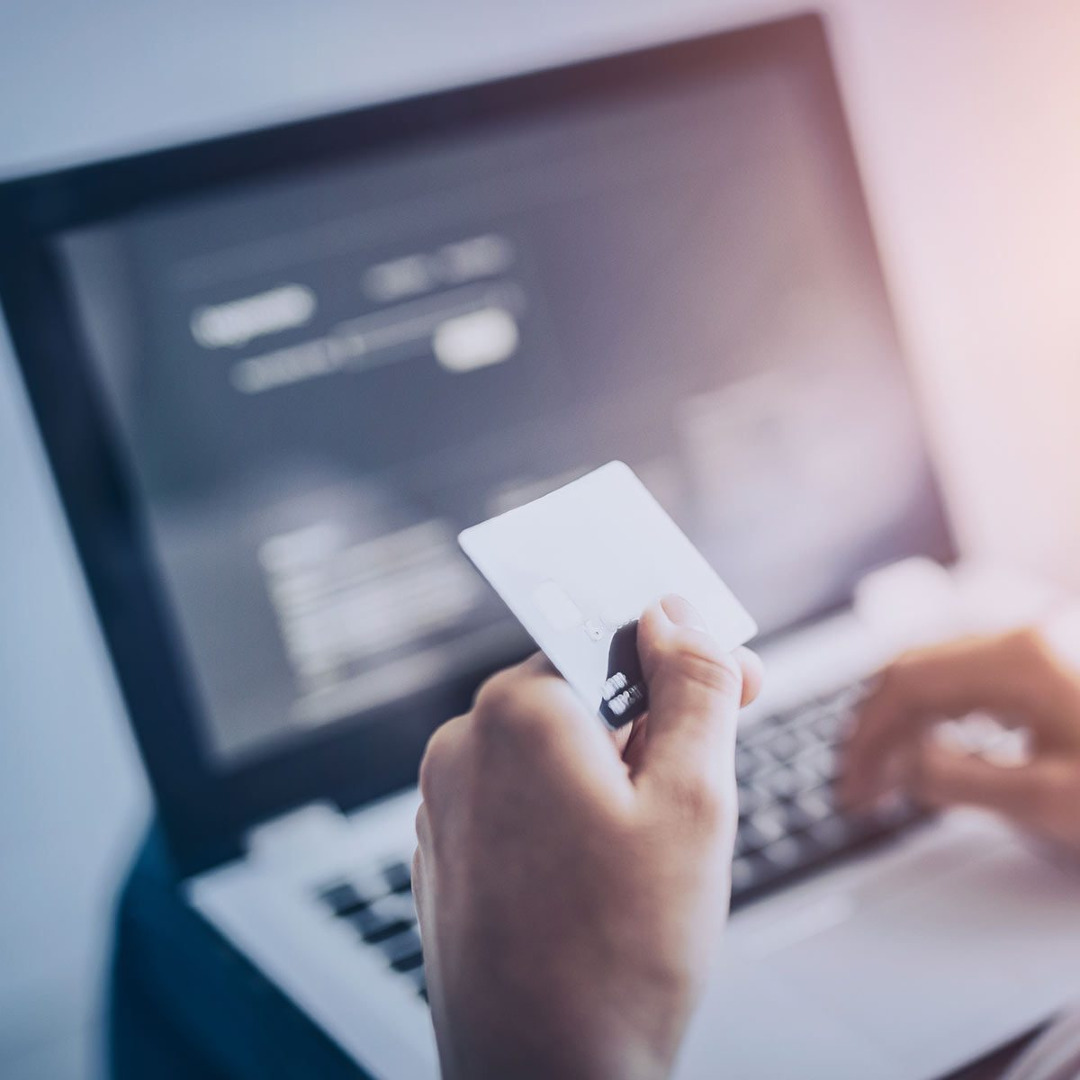 Picture of someone entering their credit card information into a laptop