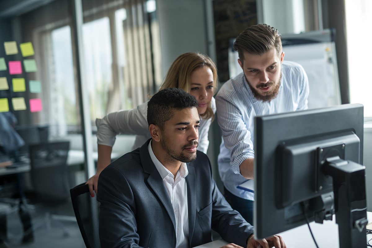 Business colleagues working together on a computer in an office.